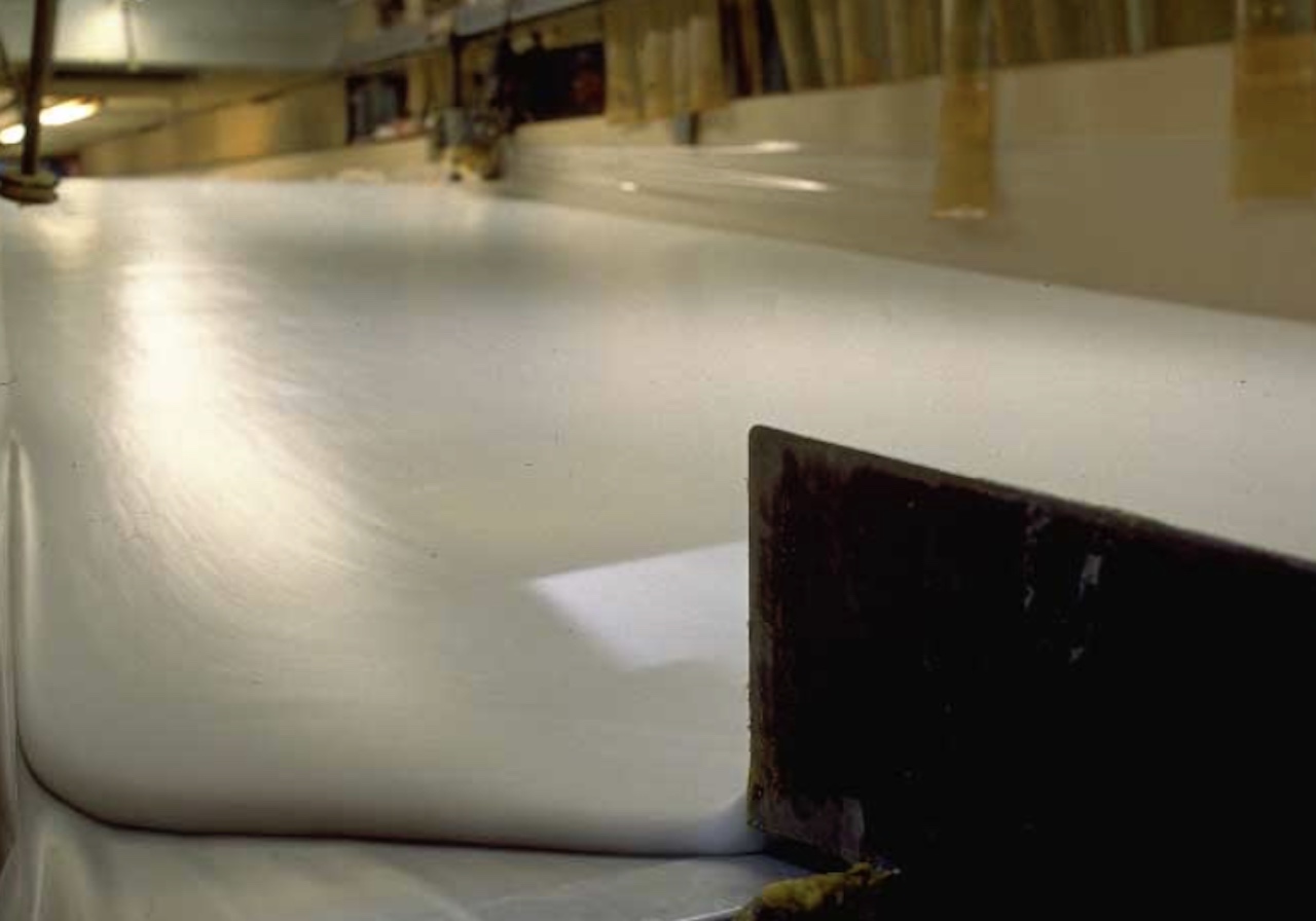 Memory foam mattress liquid being poured onto a conveyor