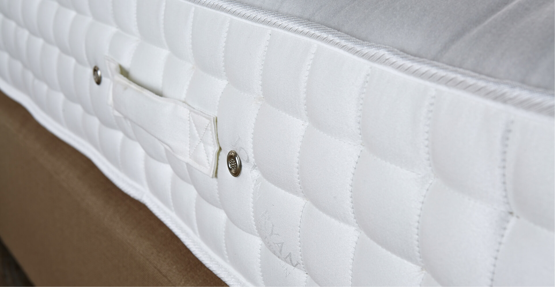 A white mattress viewed from the side