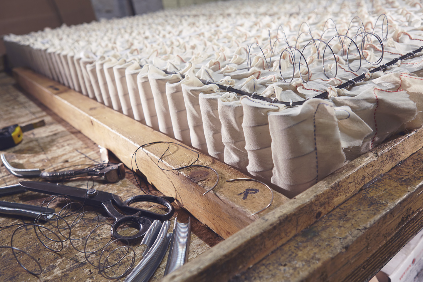 Calico pocket springs with hand stitching tools