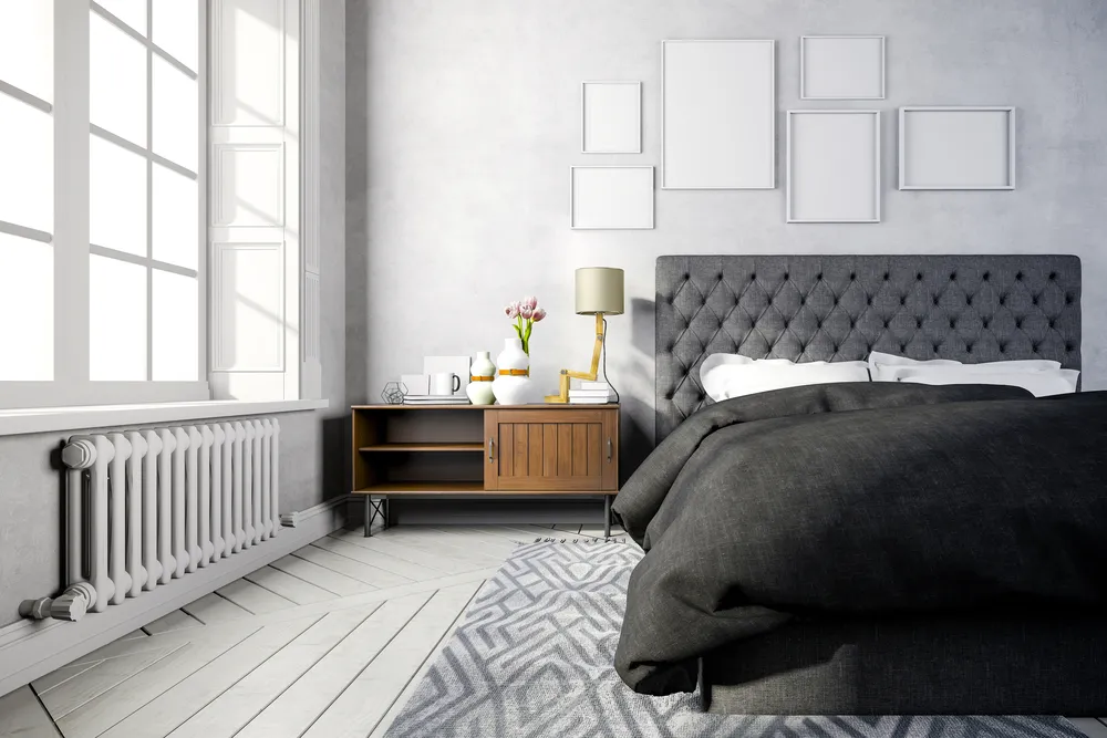 A bedroom and rug with a grey colour scheme