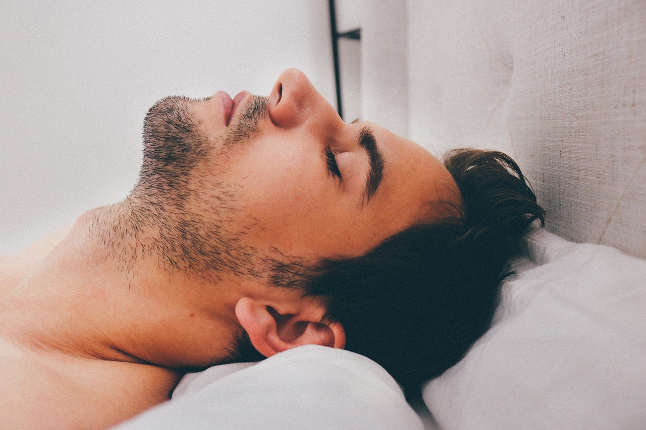 A man sleeping with his head back