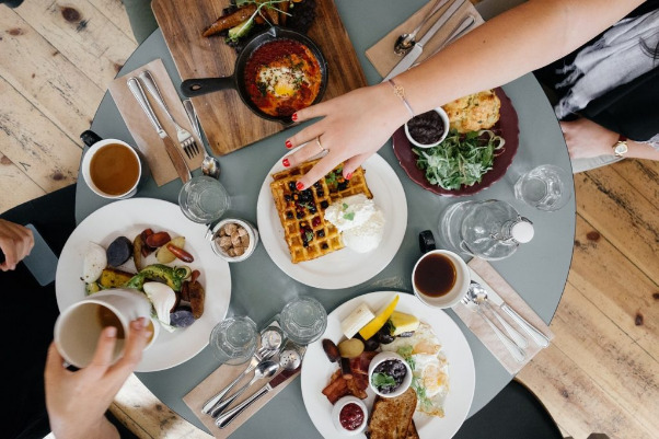 An aerial view of people eating at a dining table