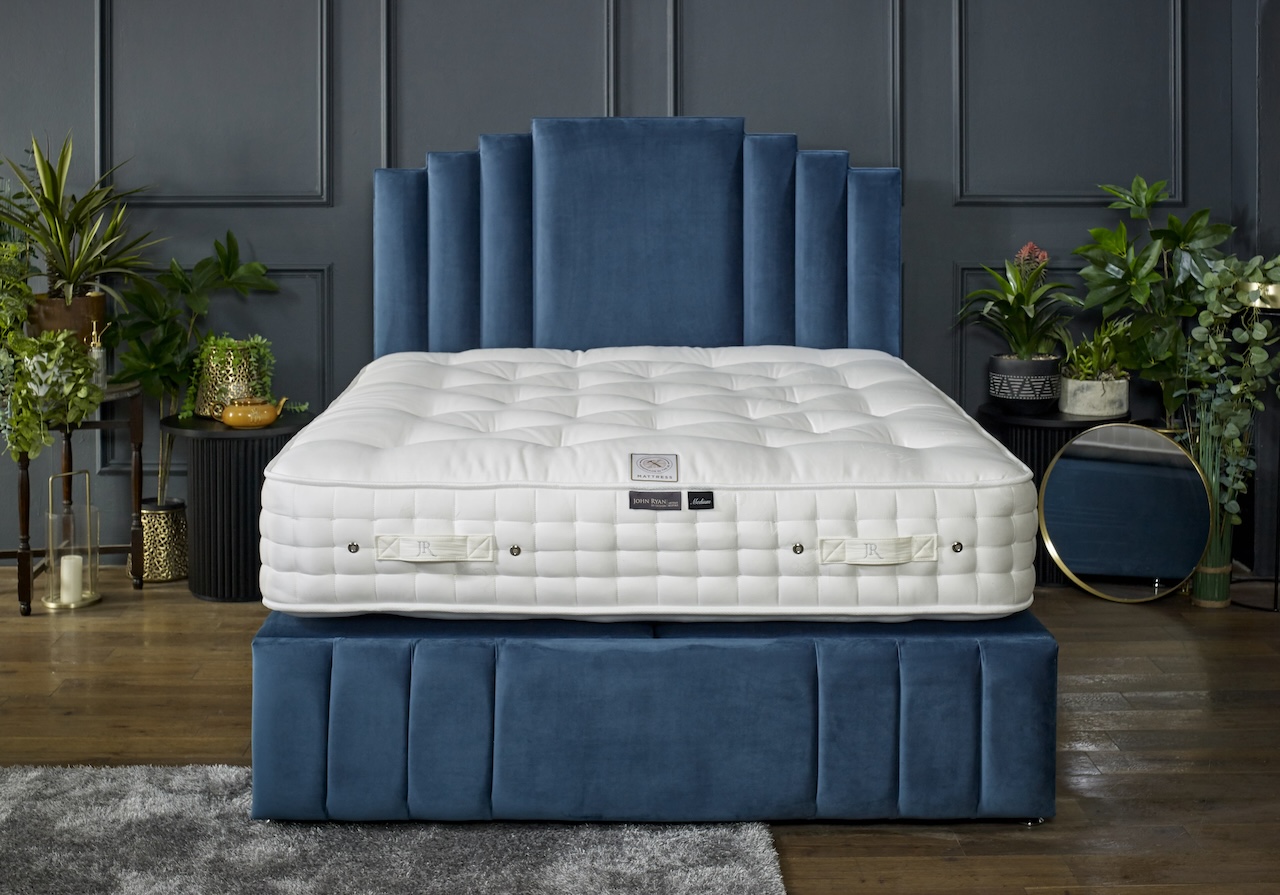 A John Ryan Artisan Naturals mattress on blue bed base