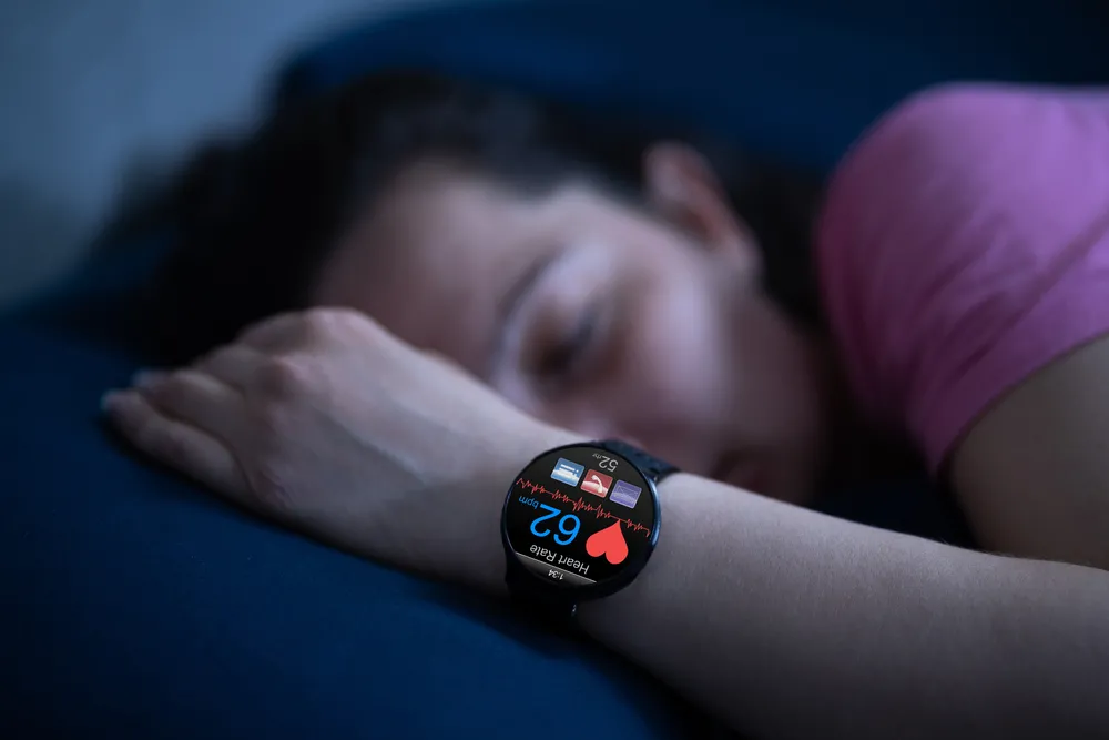 A woman using a sleep tracker