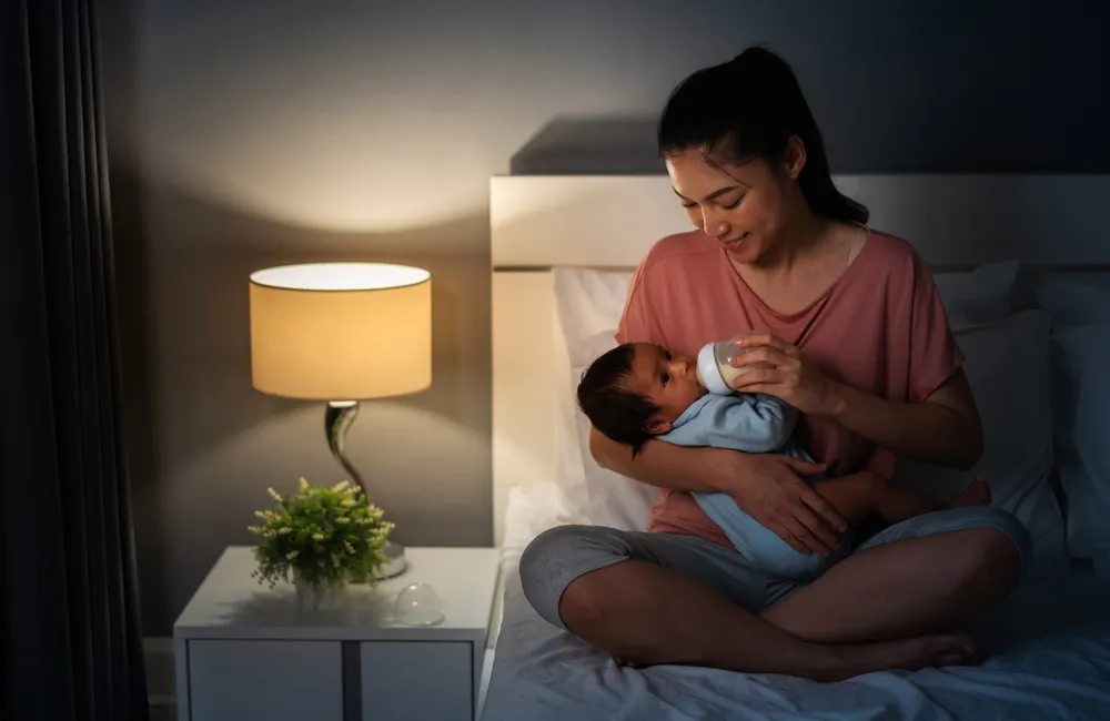 mother feeding bottle to baby