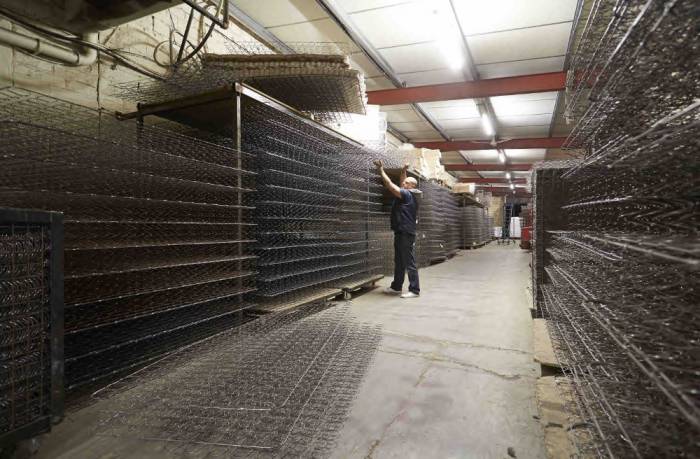 Cage sprung open coil mattresses being stored in a warehouse