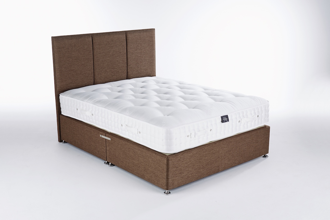 A brown bed base with a mattress