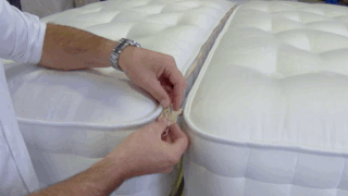 A zip and link mattress being zipped